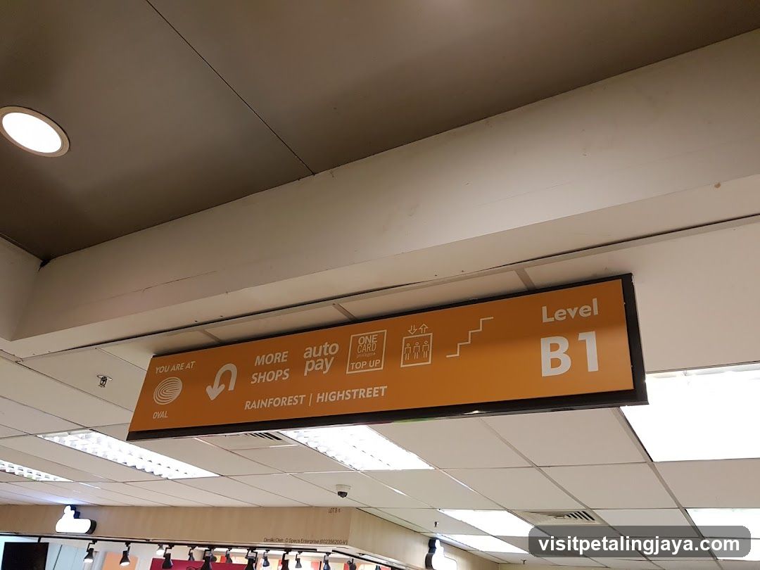 Orange directional sign in a mall or shopping center