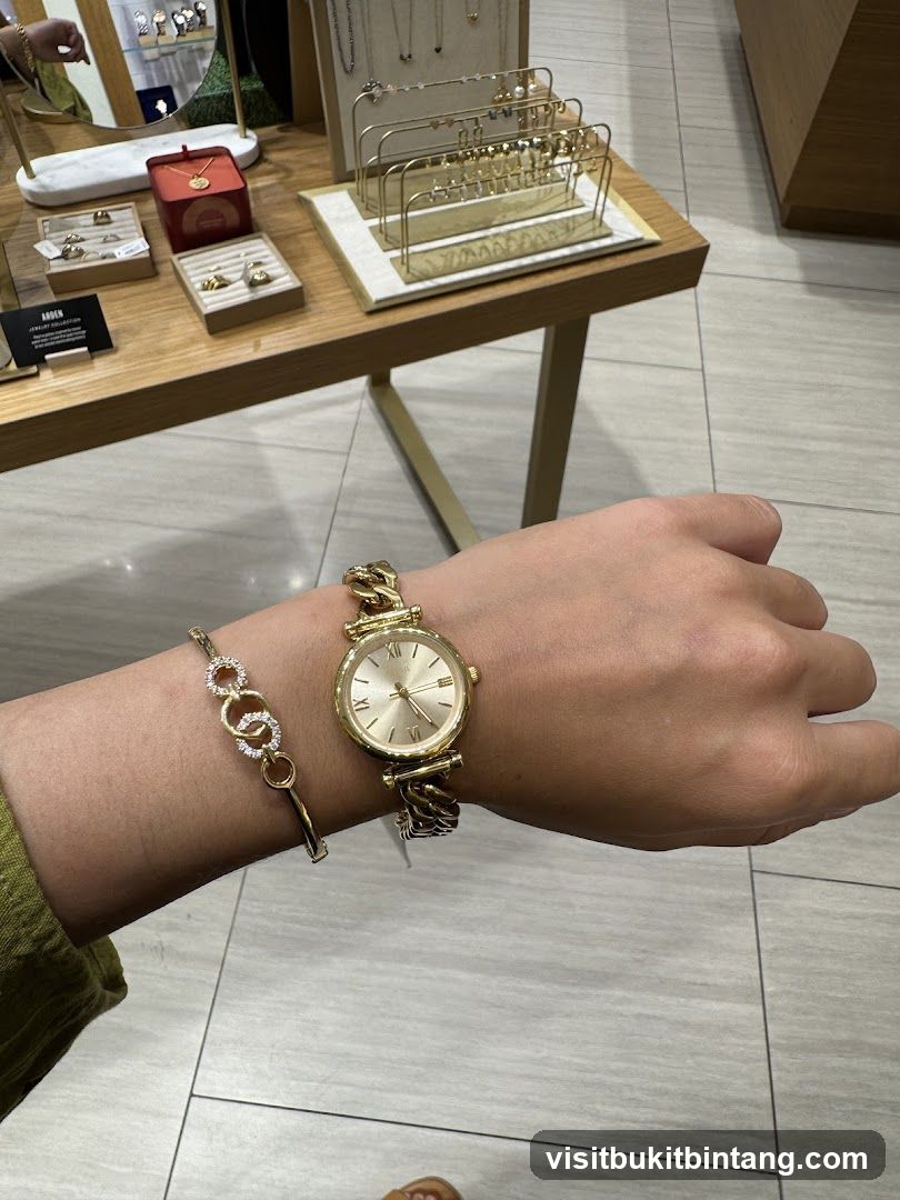 Woman wearing a gold watch and bracelet