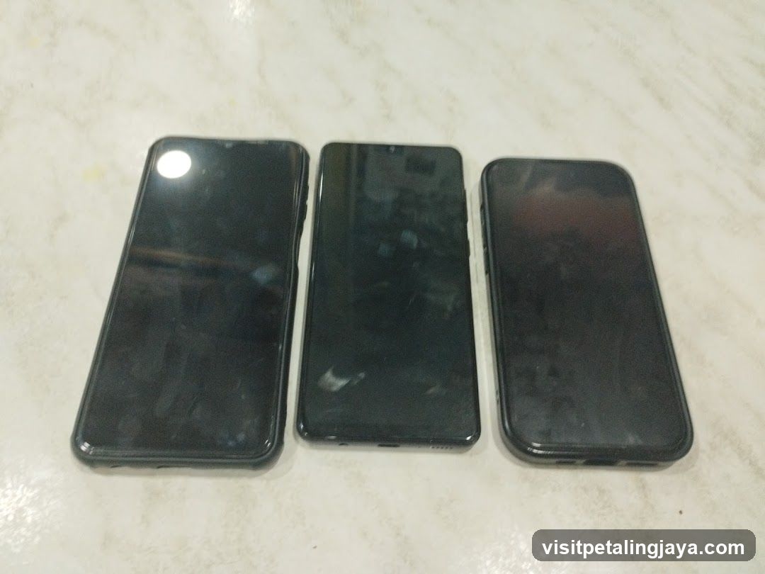 Three smartphones on a marble surface