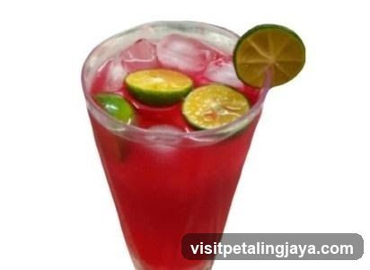 Red Citrus Drink with Lime Garnish