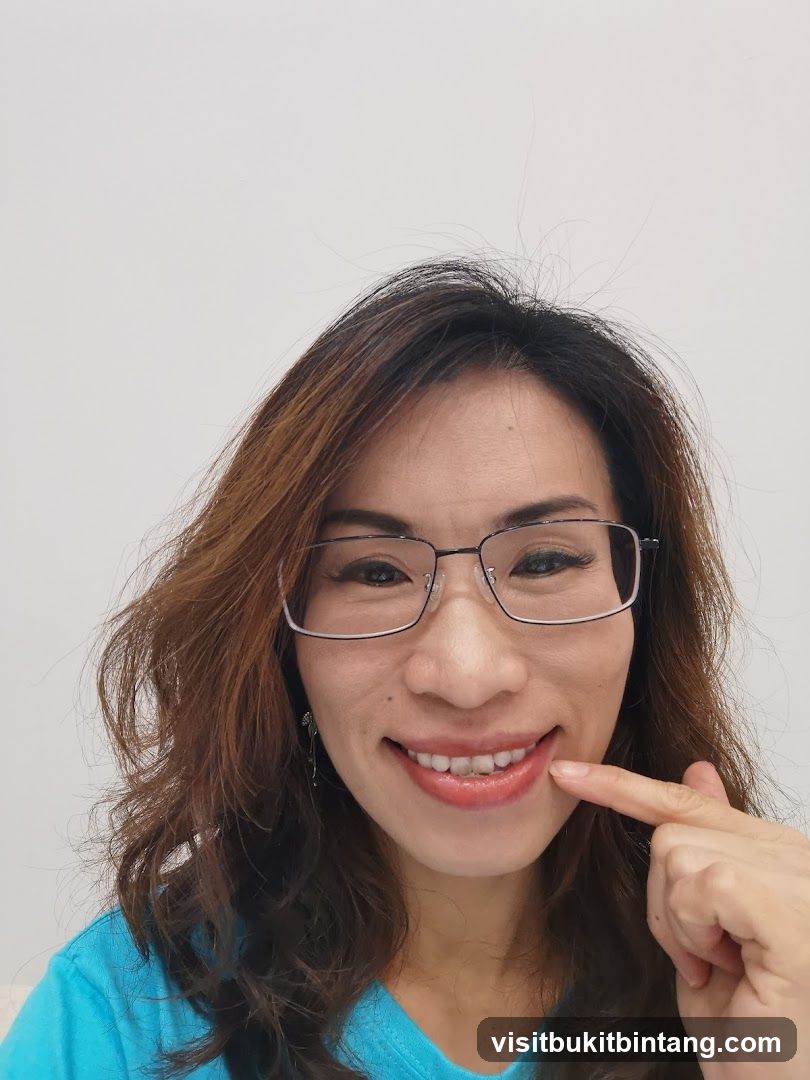 Woman pointing at her teeth