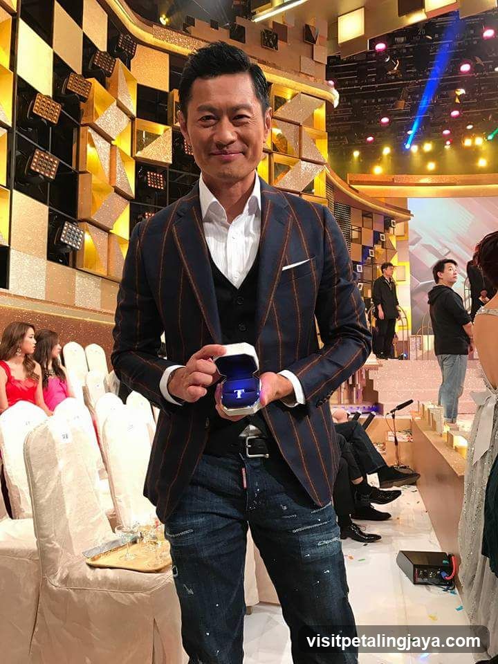 Man holding ring box at event