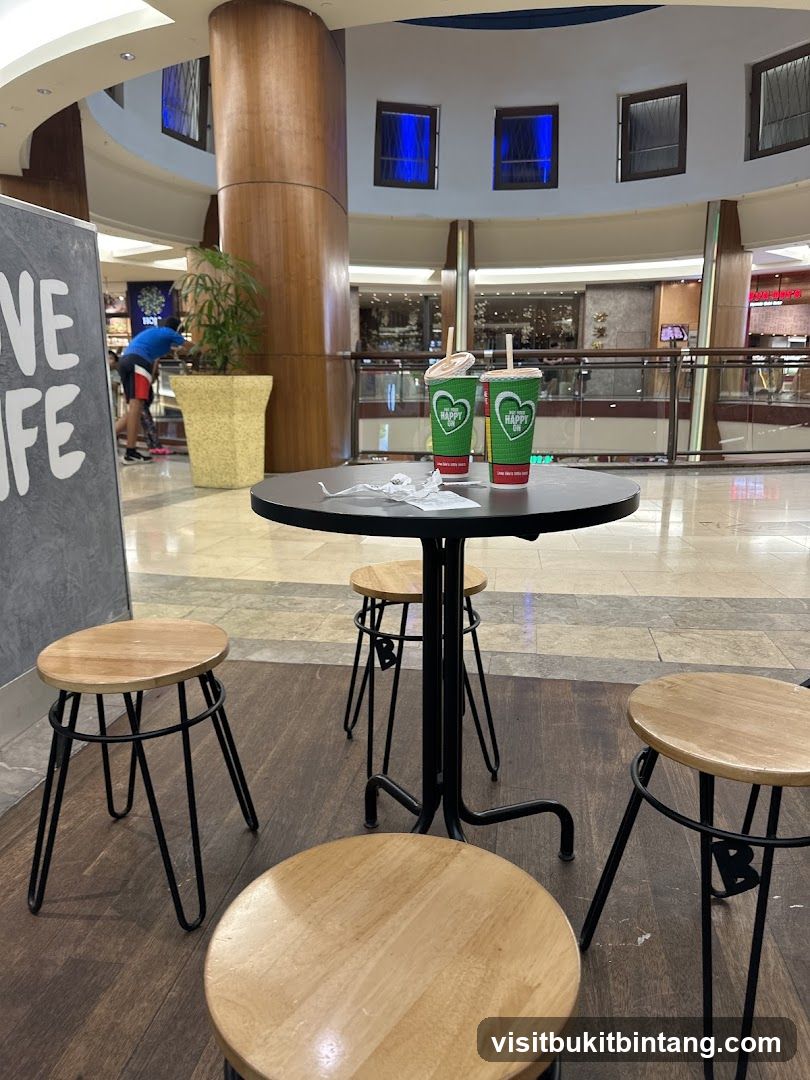 Table with drinks and stools in a mall