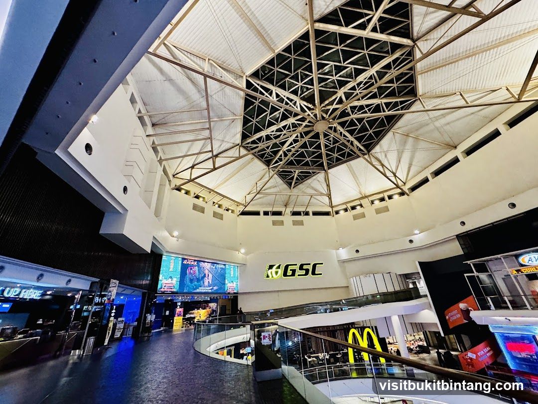 Interior of a shopping mall with a large screen and GSC logo