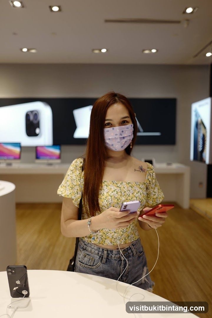 Woman holding phones in electronics store