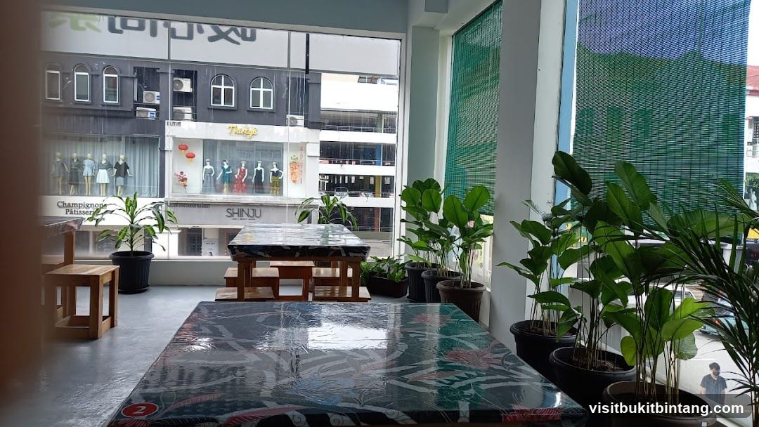 Indoor seating area with plants and view of street