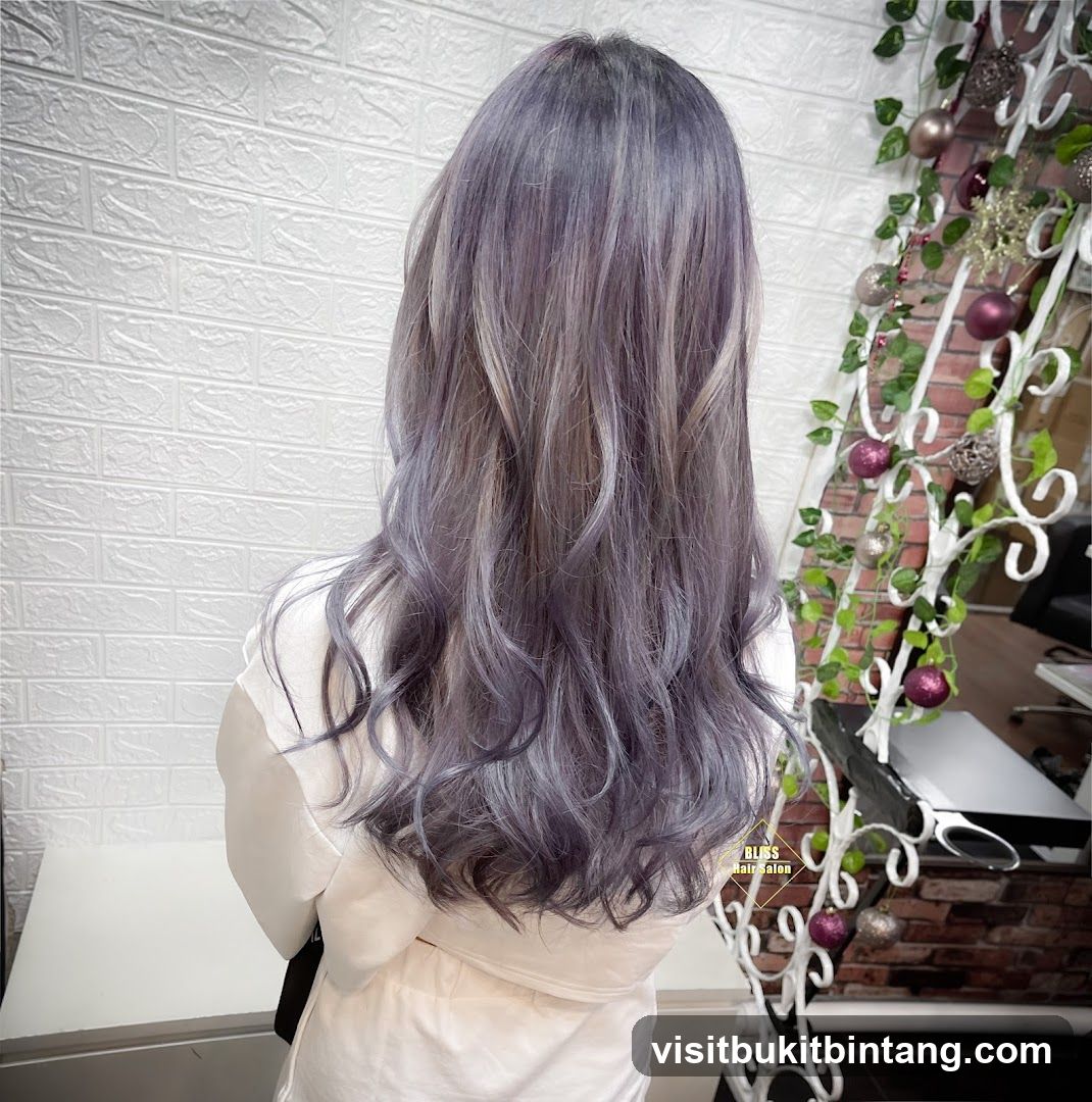 Woman with long, wavy, purple-grey hair