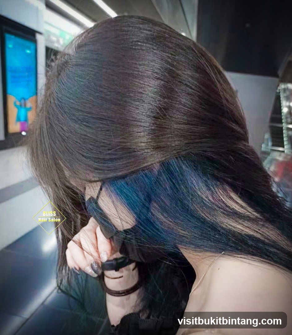 Woman with dark hair and blue highlights