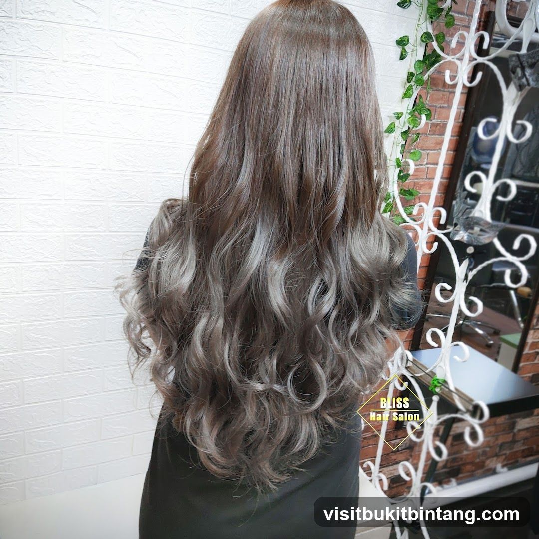 Woman with long, wavy, ash-brown hair
