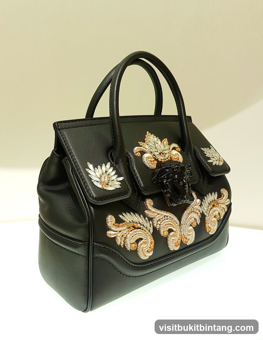 Black Leather Handbag with Medusa Head Embellishment