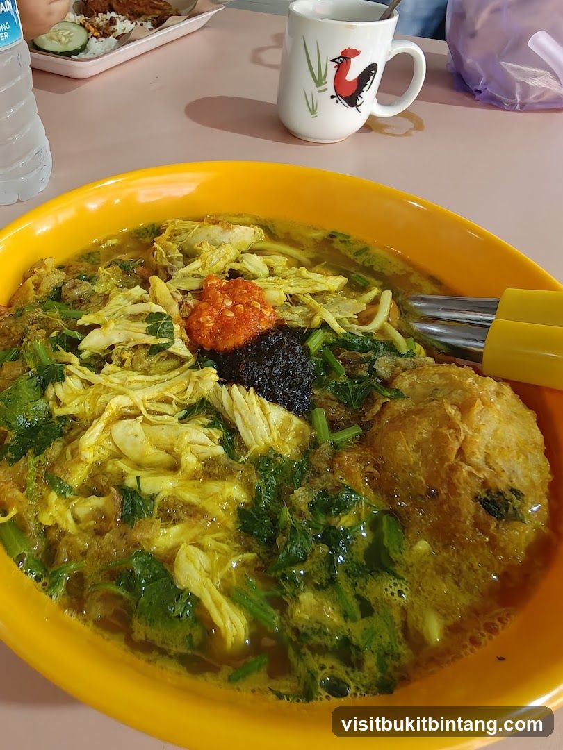 Bowl of Soup with Shredded Chicken and Condiments