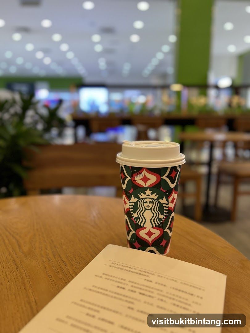 Starbucks cup and book on table