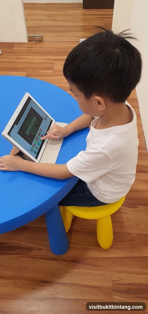 Child using a tablet at a table