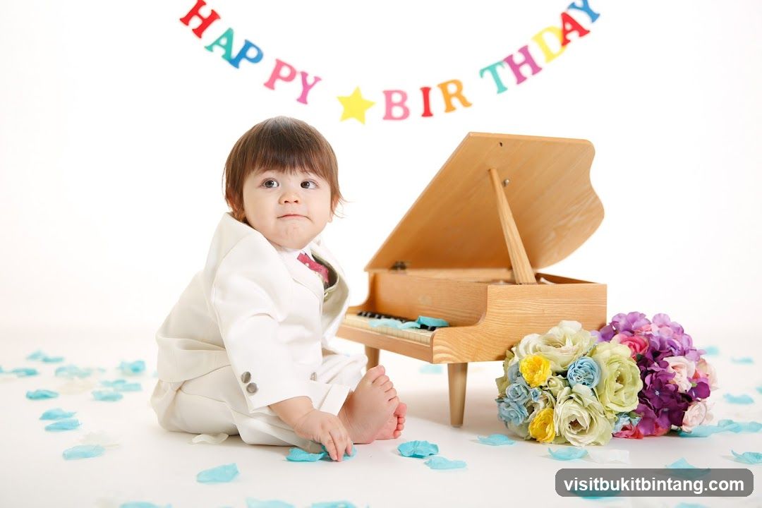 Baby in a suit with a toy piano