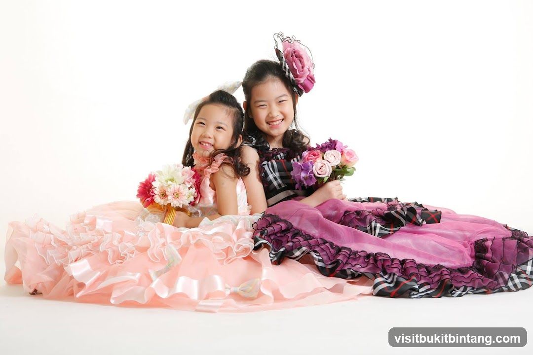 Two girls in formal dresses holding bouquets