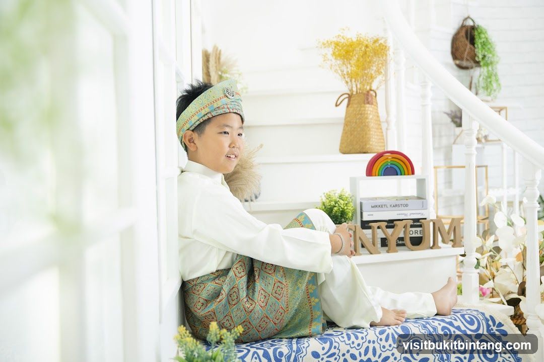 Boy in Traditional Attire Sitting on Stairs