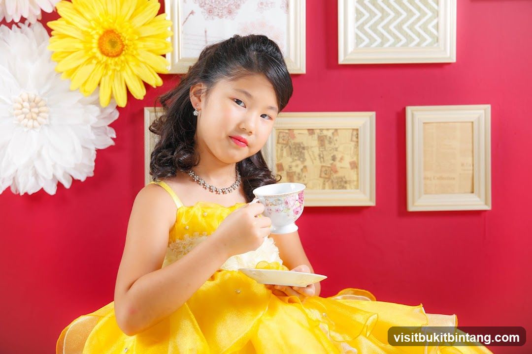 Girl in Yellow Dress Holding Teacup