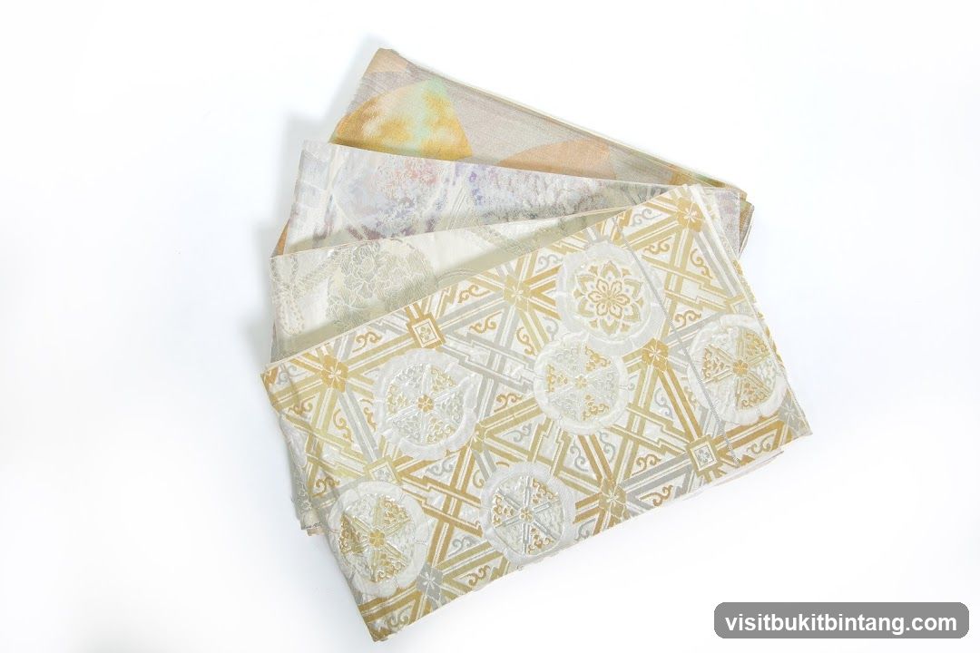 Four folded fabrics with intricate patterns