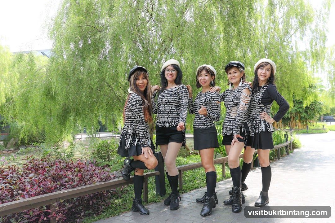 Five women posing in a park