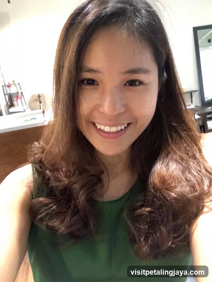 Woman with wavy hair smiling in a salon or beauty shop interior