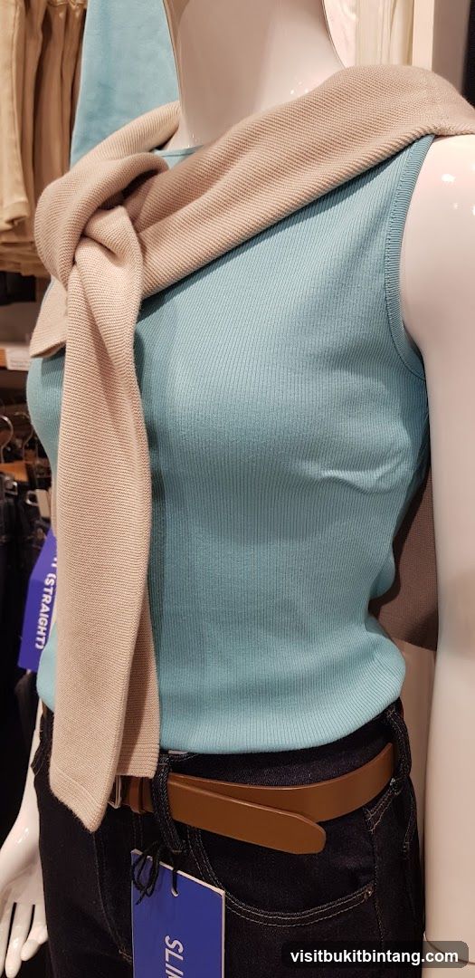 Mannequin wearing a blue tank top and jeans