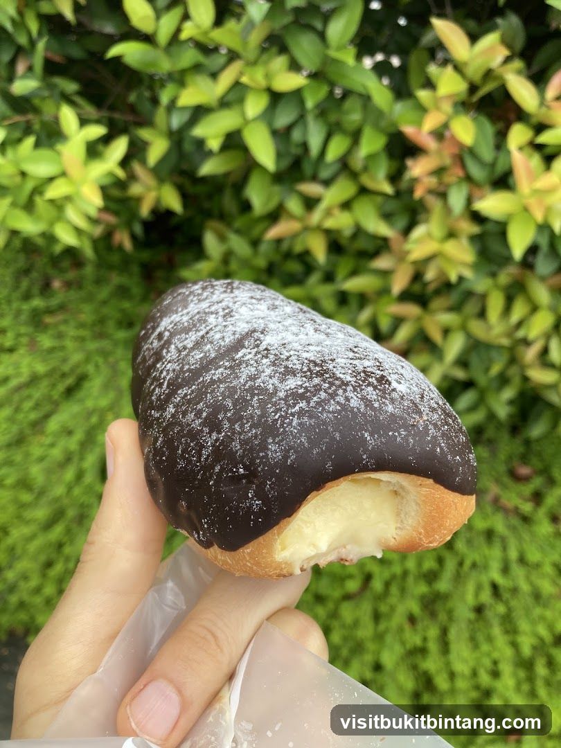Chocolate-covered pastry with cream filling