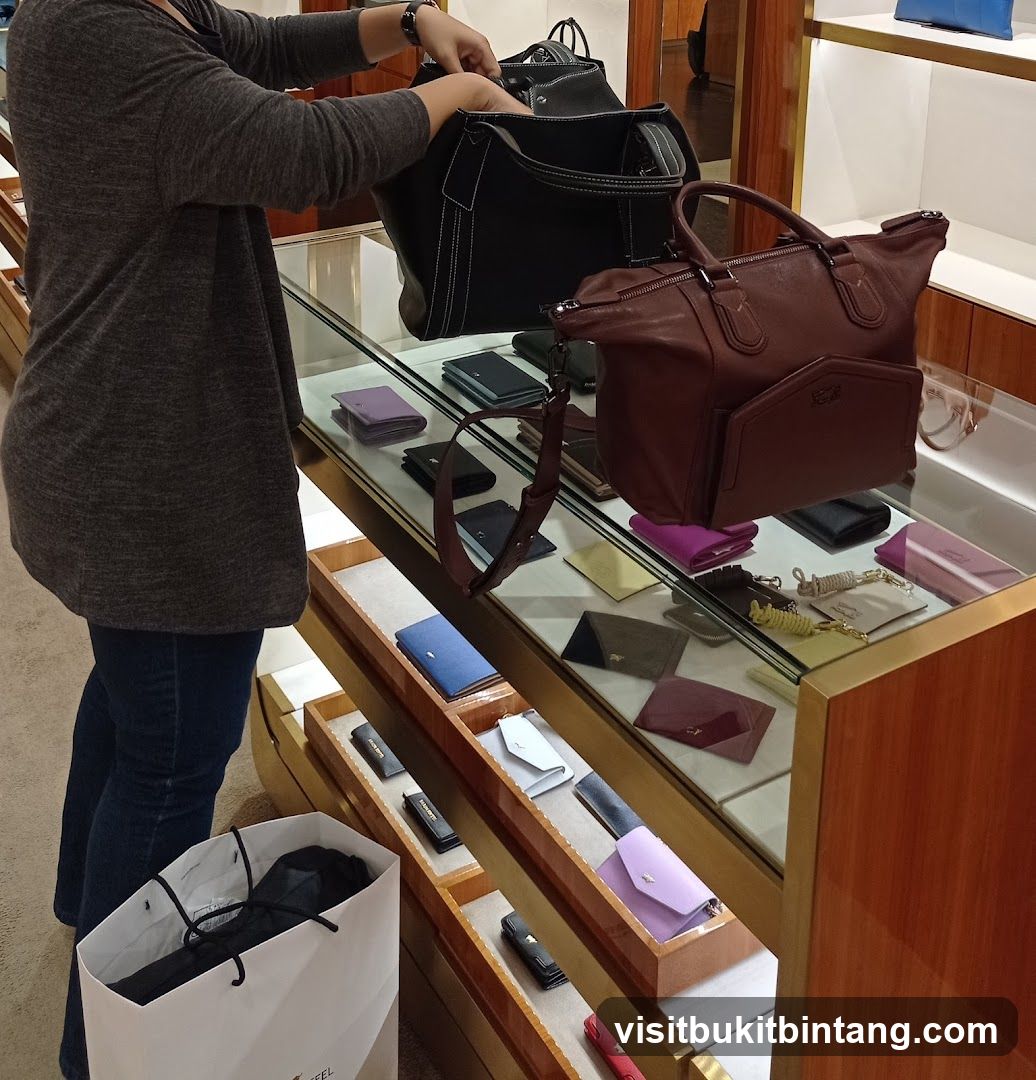 Woman browsing handbags and wallets in a store
