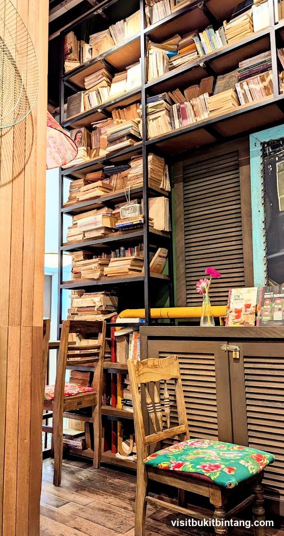 Cozy cafe interior with bookshelves and chairs