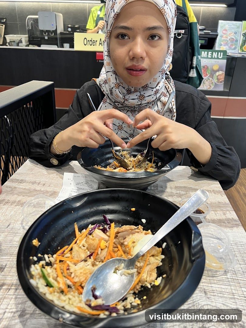 Woman making heart shape with hands over food