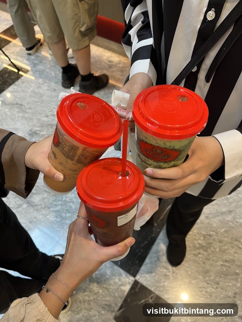 Three drinks being held up