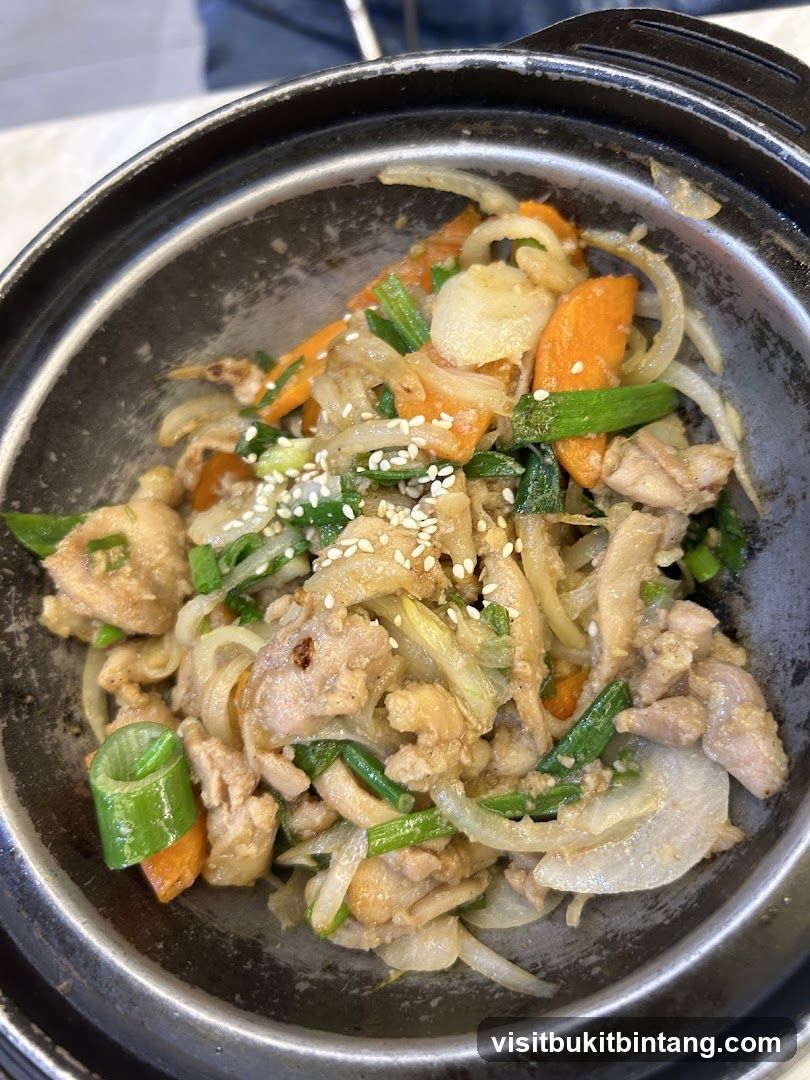 Stir-fried dish with chicken, carrots, and onions