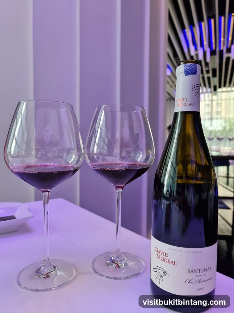 Two glasses of red wine and a bottle of wine