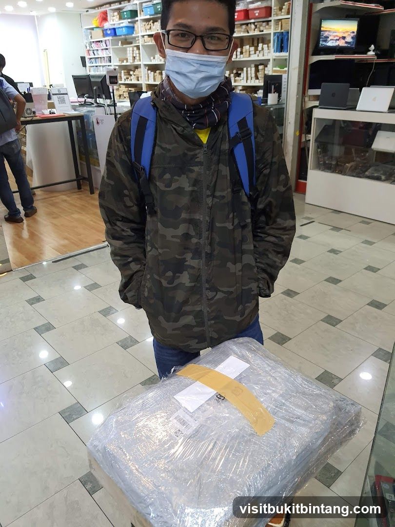 Man with Package in Electronics Store