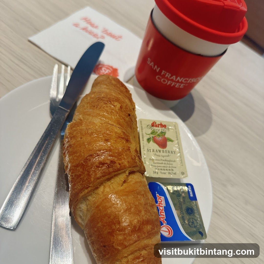 Croissant with coffee and condiments