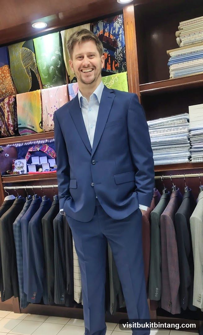 Man in a blue suit in a tailor shop