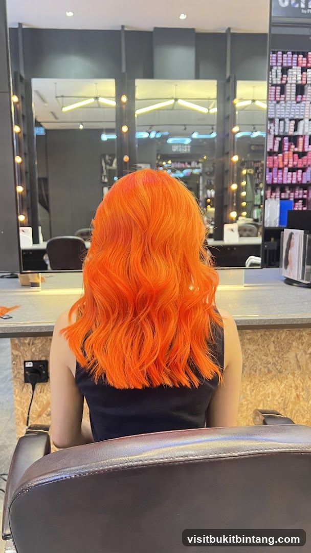 Woman with vibrant orange hair in a salon