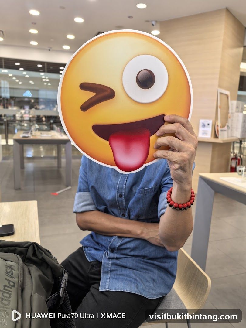 Person holding an emoji cutout