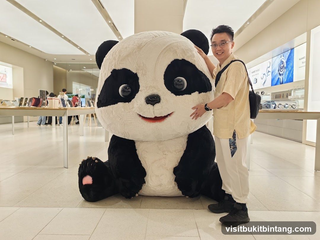 Man Posing With Giant Panda Plush Toy