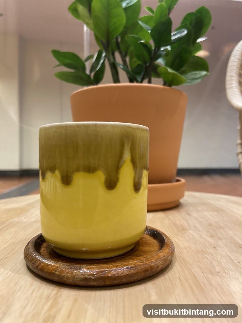 Yellow cup on wooden coaster
