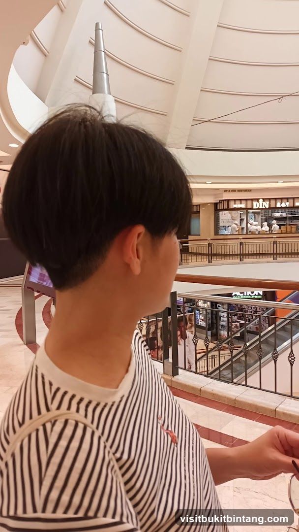 Person in a striped shirt looking at a food establishment