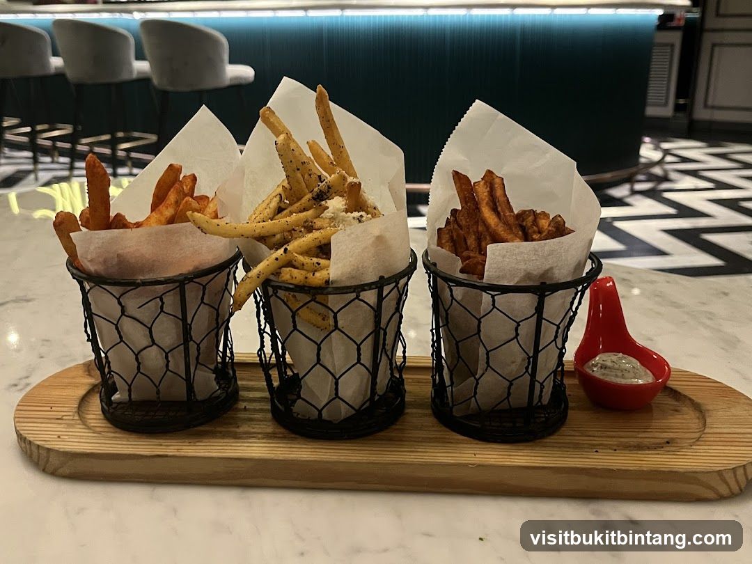 Three types of fries served with dipping sauce