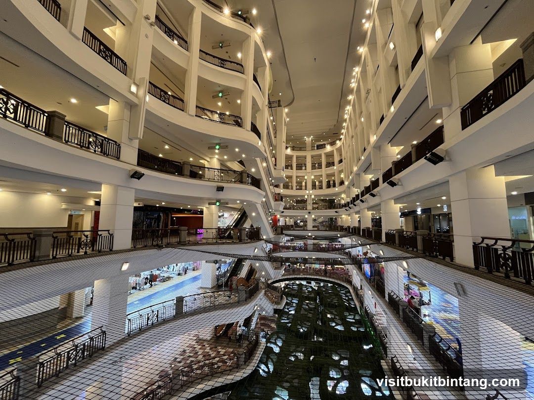 Interior of a multi-level shopping mall with a central atrium