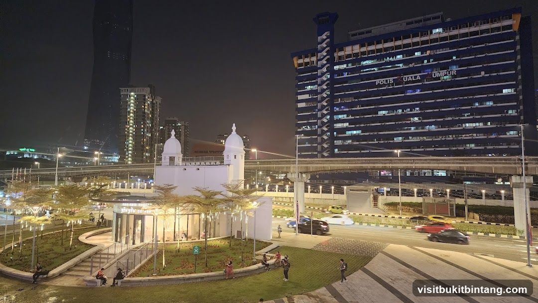 Nighttime Cityscape with Modern Architecture and a Small Building