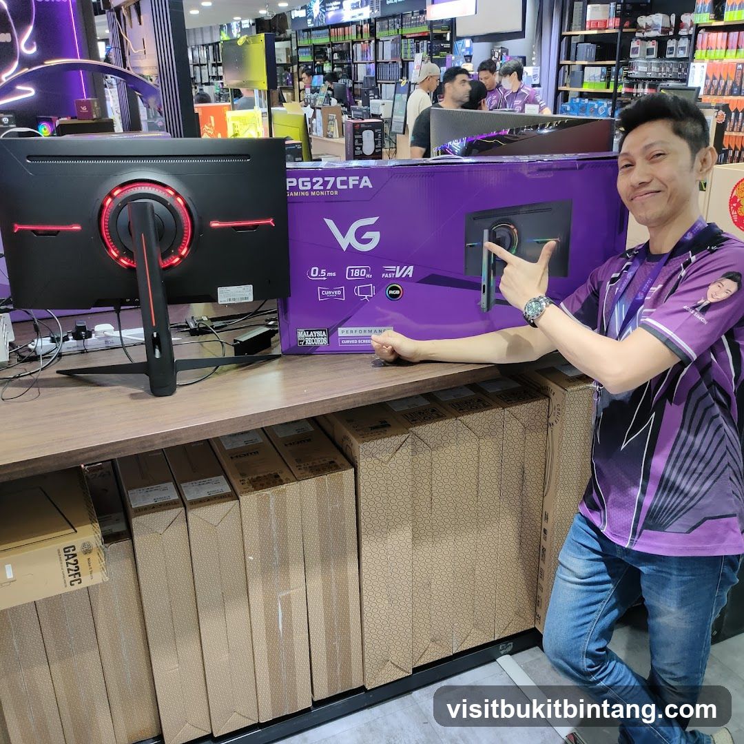 Man Posing with Gaming Monitor