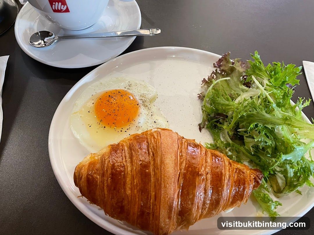 Breakfast Plate with Croissant, Fried Egg, and Salad