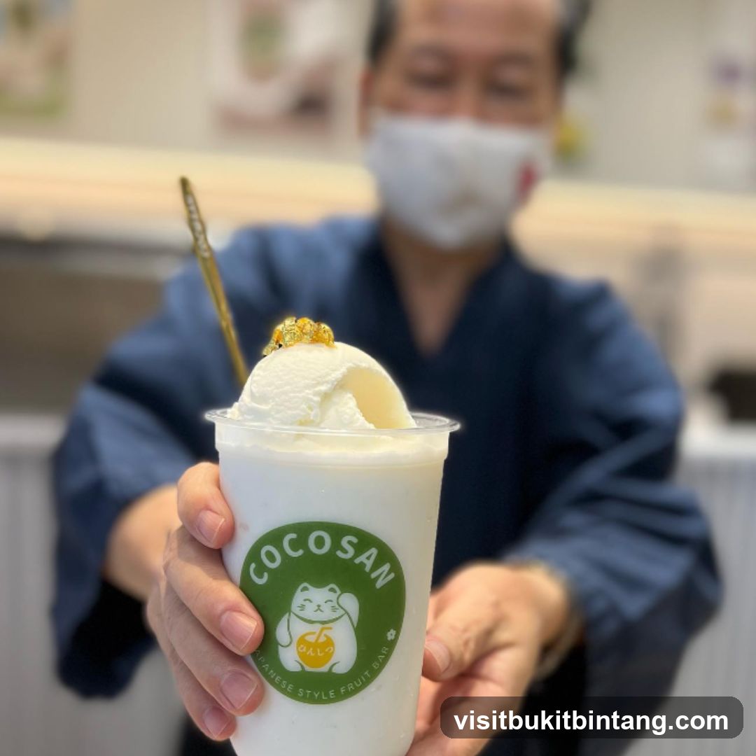 Man holding a drink with ice cream