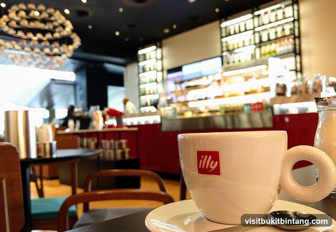 Coffee cup with Illy logo in a cafe