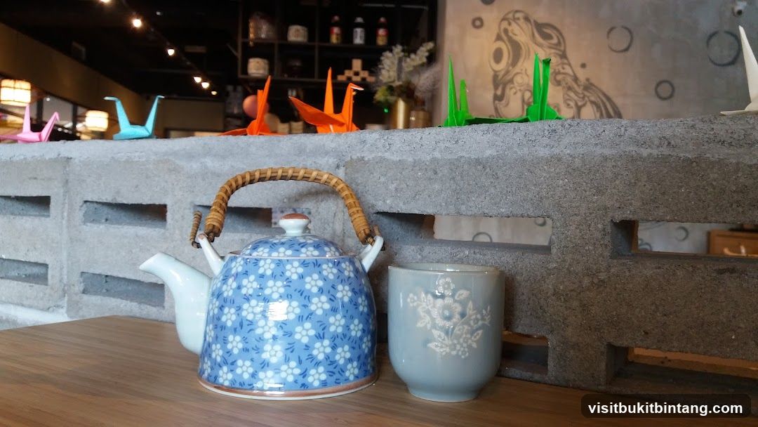 Teapot and cup with origami cranes