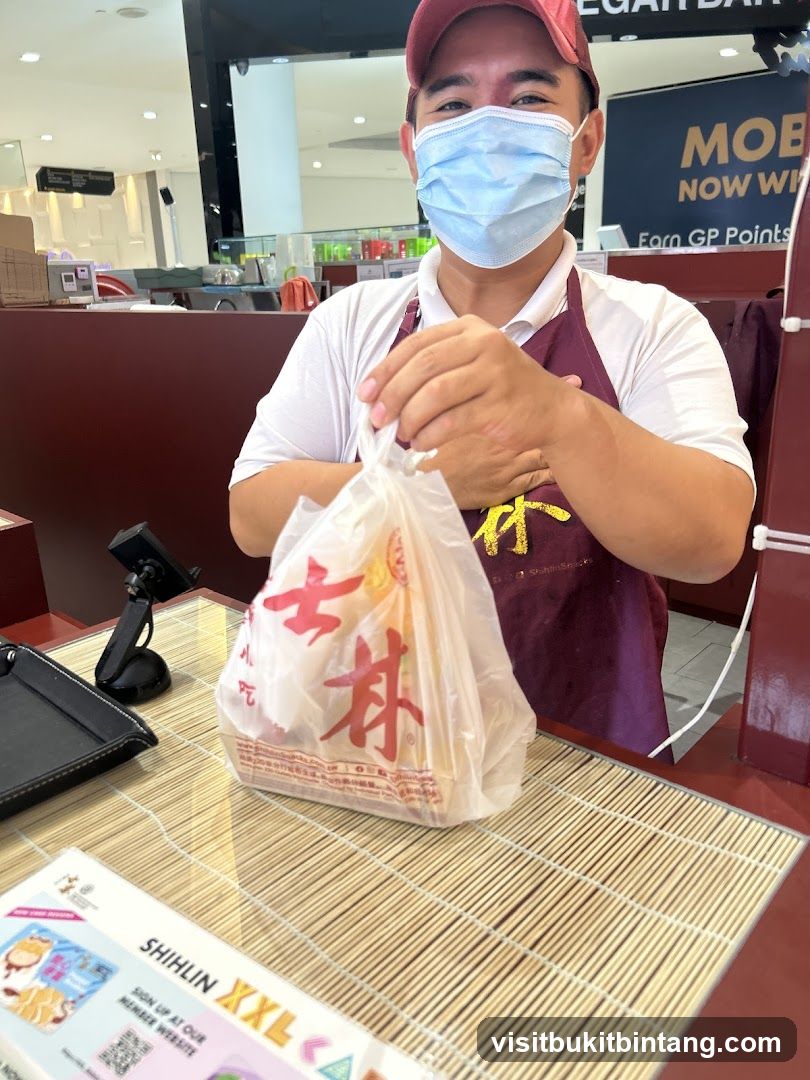 Staff holding a takeout bag