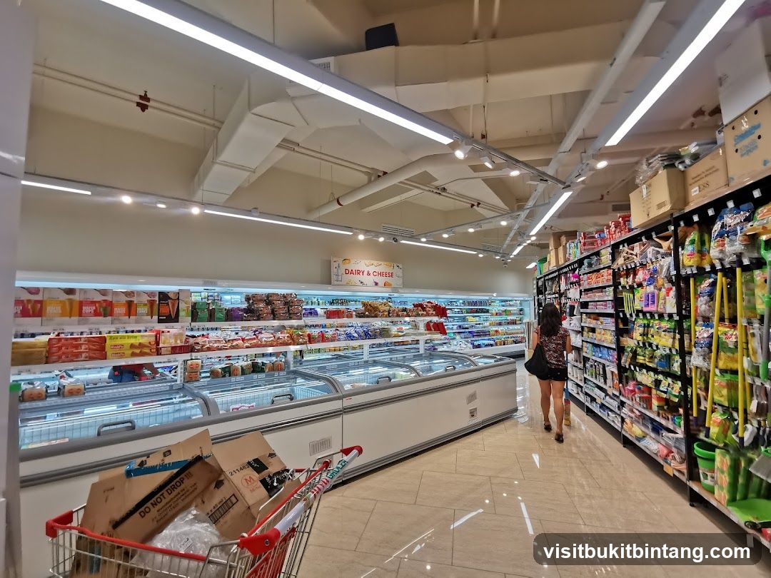 Supermarket aisle with frozen goods and shelves of products